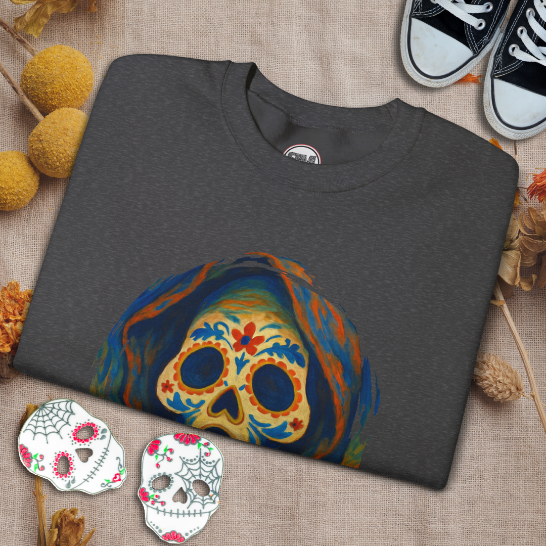 Gray t-shirt with colorful skull design on a textured surface with decorative elements.