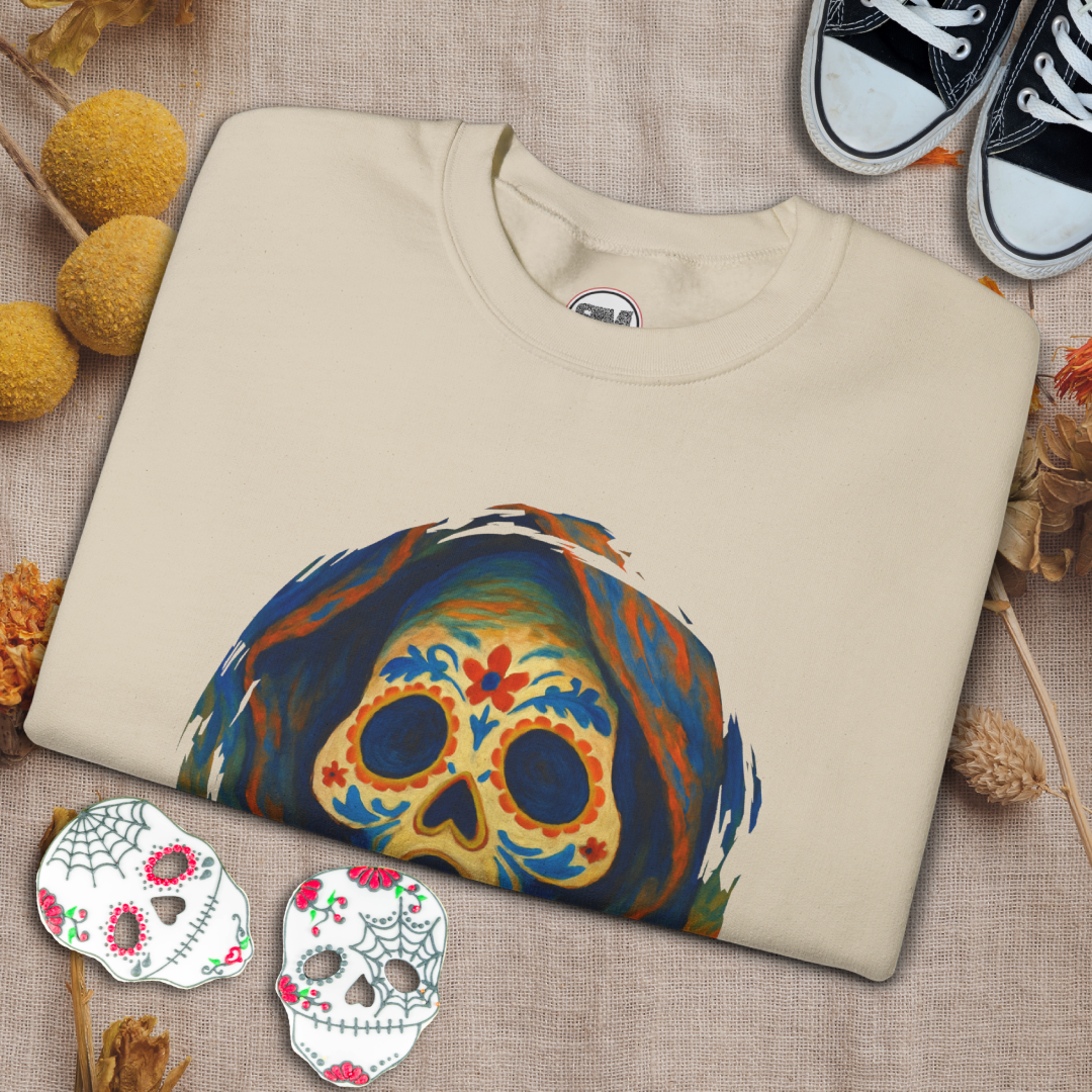 Sand sweatshirt with colorful skull design on a textured surface with decorative elements.