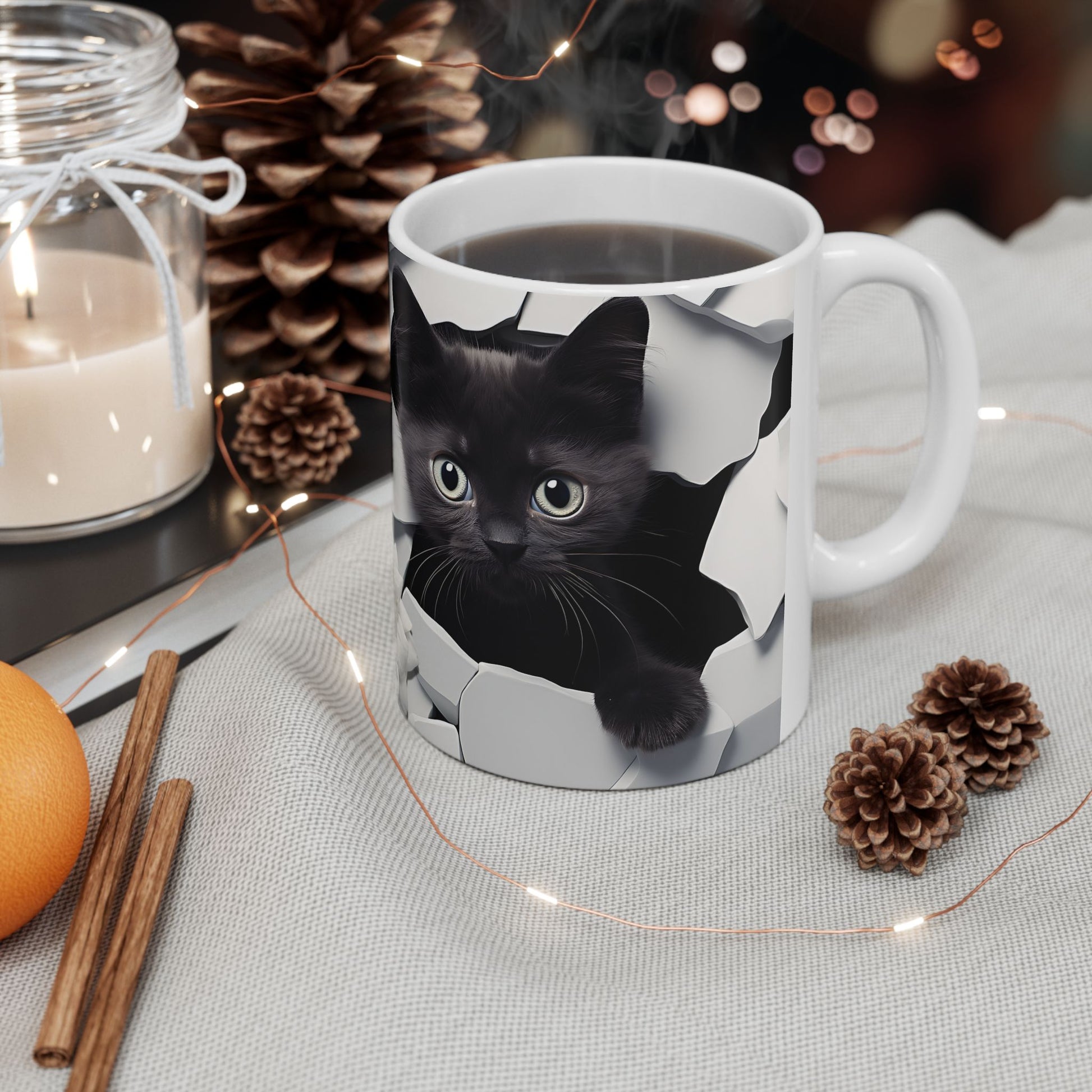 Mug with a black cat design on a table with decorative items