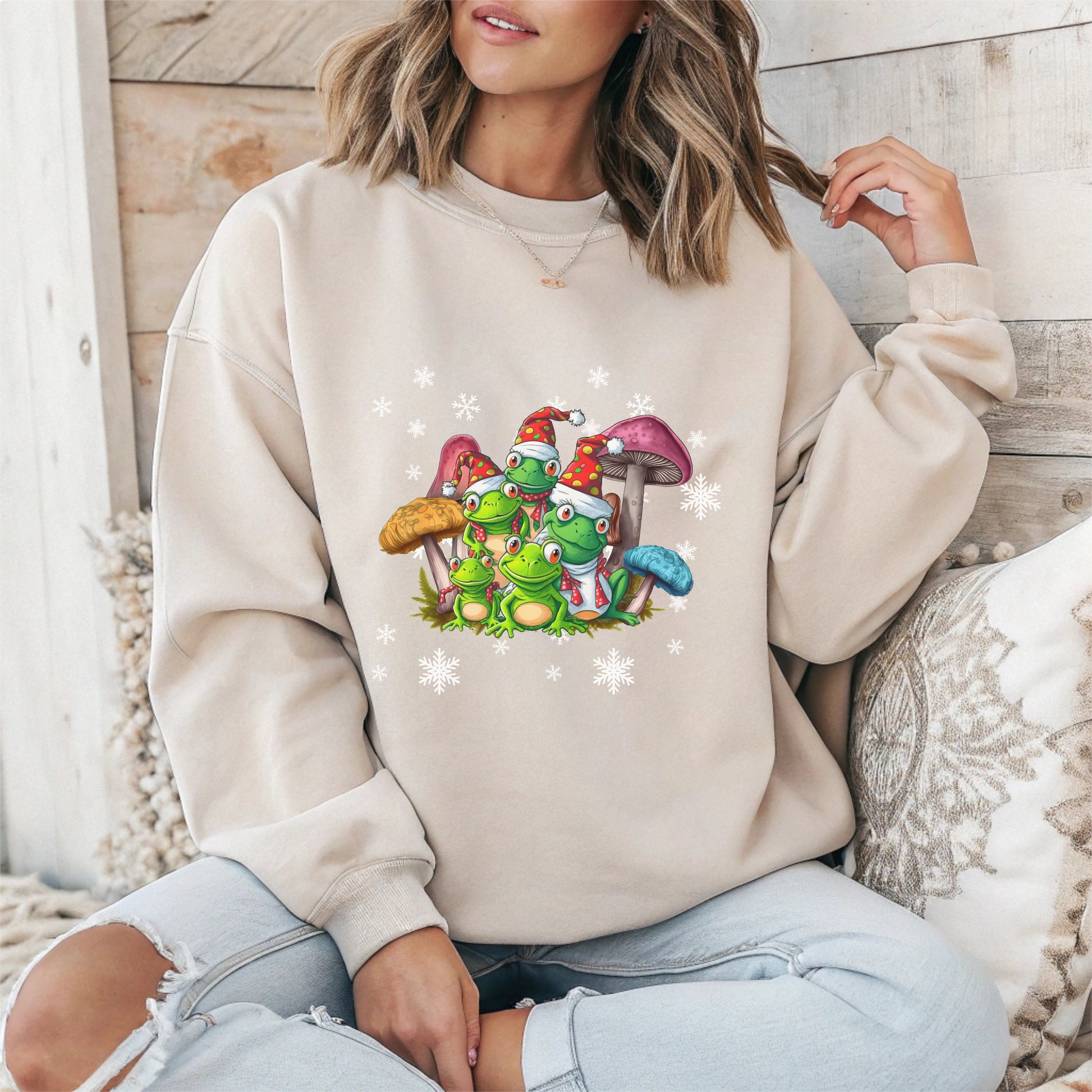 Person wearing a beige sweatshirt with cartoon characters and mushrooms design.
